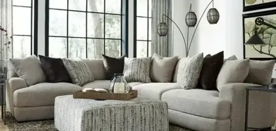 A cozy living room featuring a light gray sectional sofa