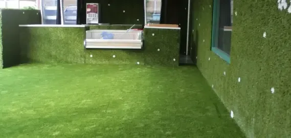 Interior of a modern space with bright green artificial grass flooring