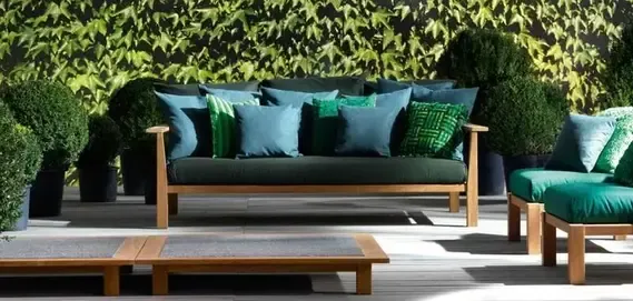 Stylish outdoor seating with green and blue pillows