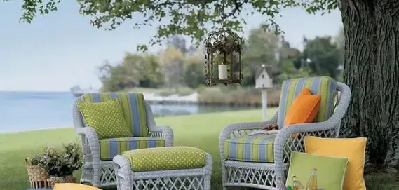 outdoor seating area by a lake, featuring striped chairs